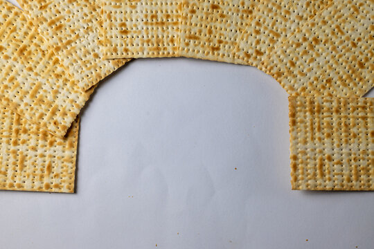 Unleavened Passover matzah arranged on white background