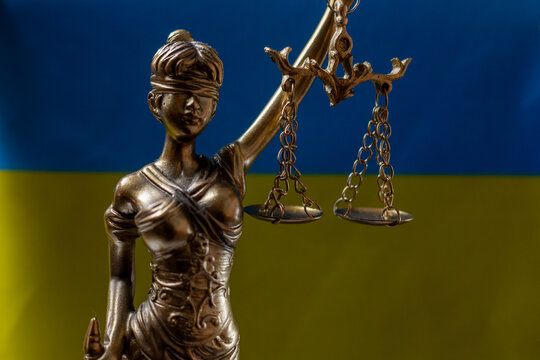 Ukrainian flag with Lady Justice statue and scales