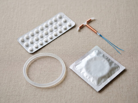 Variety of Modern Contraceptive Methods on Neutral Textile Surface