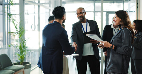 Business people, seminar or handshake for welcome, partnership or introduction with smile. Convention, happy group or shaking hands at networking workshop, meeting or office greeting with document © peopleimages.com