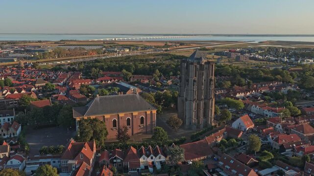 Stunning aerial perspective of zierikzee, a historic city in zeeland. The prominent sint lievensmonstertoren and the city center are bathed in golden light