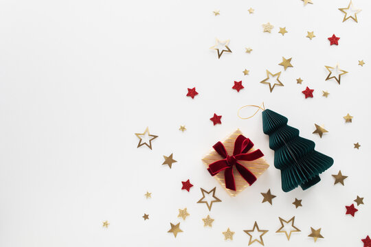 Christmas gift or present box with festive fir tree and golden stars top view, flat lay. New Year greeting card.