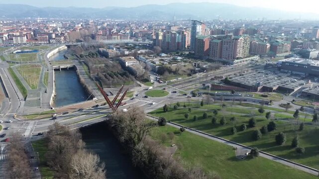 Overhead perspective of Turin's Parco Dora former industrial site transformed into a modern public park against the Alps, Italy