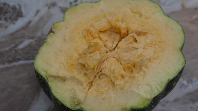 Cross-section of a fresh raw green pumpkin showing texture and inside pulp