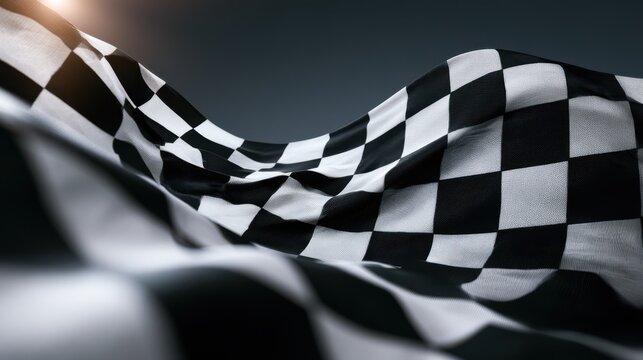 A close-up of a waving black and white checkered racing flag symbolizing the finish line in motorsport events.