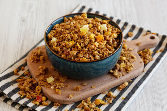 Crispy Granola with Tropical Fruits in a Bowl, side view.