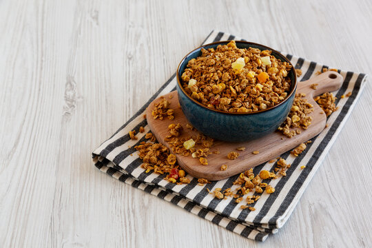Crispy Granola with Tropical Fruits in a Bowl, side view. Copy space.