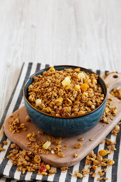 Crispy Granola with Tropical Fruits in a Bowl, side view. Copy space.
