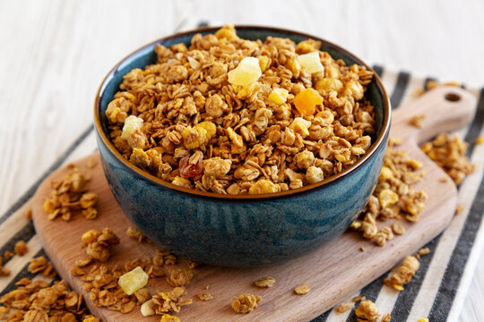Crispy Granola with Tropical Fruits in a Bowl, side view.