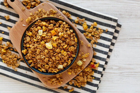Crispy Granola with Tropical Fruits in a Bowl, top view. Copy space.