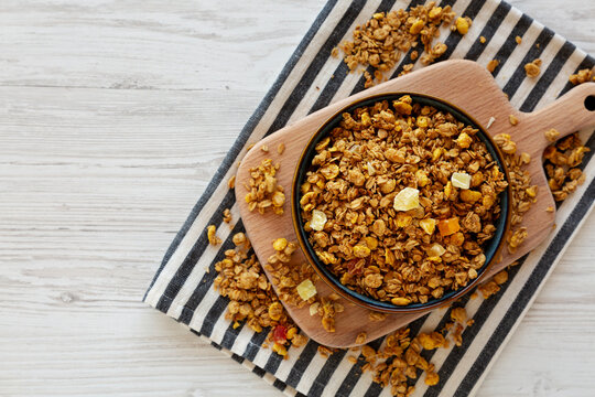 Crispy Granola with Tropical Fruits in a Bowl, top view. Copy space.