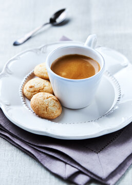 Cup of coffee with cookies on linen napkin, selective focus