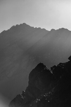 Jagged mountain peaks with hazy light rays