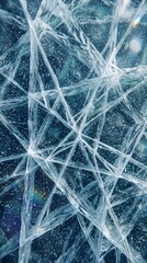 Fototapeta premium Frozen blue ice texture background with sharp cracks and frozen air bubbles forming geometric patterns under winter light for cold nature abstract design, wallpaper, and seasonal backdrop.