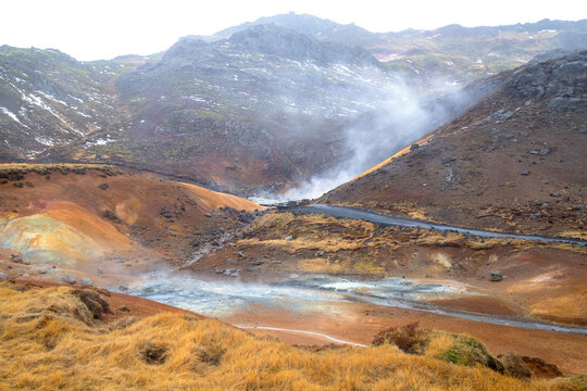 Geothermal Landscape with Steam Vents and Wooden Boardwalks in Iceland