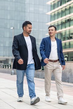 Technology startup founders walking discussing business in city