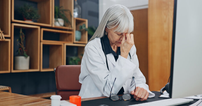 Stress, headache and doctor in office at hospital with fatigue, burnout or bad news on patient results. Woman, migraine and mature healthcare worker with exhaustion for medical mistake in clinic.