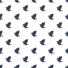 Naklejka premium Black crows creating a repeating, decorative, and spooky flat design pattern