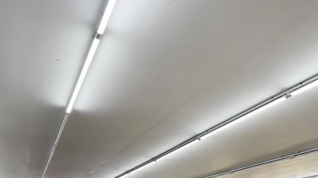 Abstract minimalist ceiling LED tube light background video with dramatic shadows