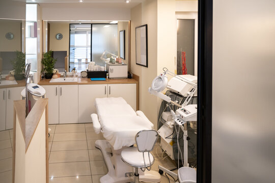 Interior view of professional aesthetic clinic room through a glass door