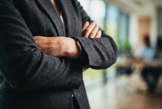 Professional person with arms crossed in office
