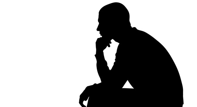 Silhouette of a man thinking and sitting