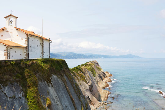 Ermita de San Telmo hermitage on steep flysch cliffs overlooking the ocean in Zumaia Basque Country Spain
