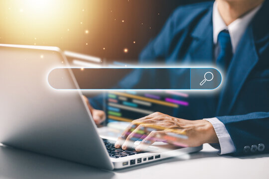 Business professional typing on laptop with search bar and coding interface, representing web search, software development, online research, SEO, programming, and information technology.