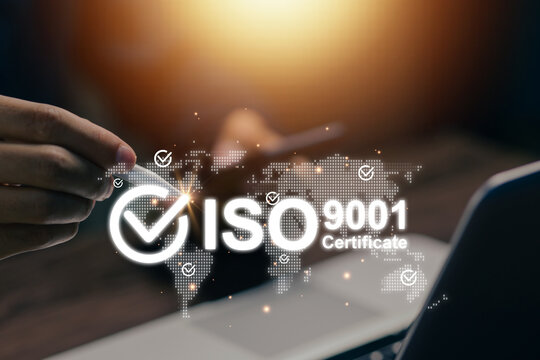Business professional using laptop with ISO 9001 certification interface and global map, representing quality management, compliance, standards, audit, and digital business assurance.