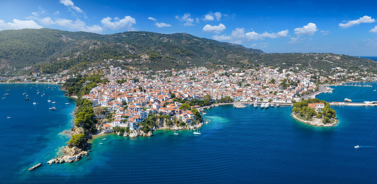 Panoramic aerial view of the town and harbour at Skiathos island, Sporades, Greece, during a sunny summer day