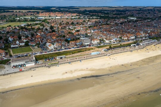 Aerial view over Bridlington showing the sandy beach seafront promenade residential streets coastal buildings beach huts and surrounding East Yorkshire countryside beside the North Sea from above