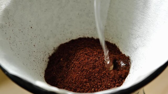 Pouring Hot Water Over Ground Coffee for Drip Brewing