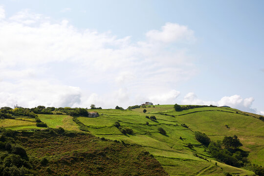 Scenic panoramic view of green rolling hills and rural farmland in Zumaia Basque Country Spain