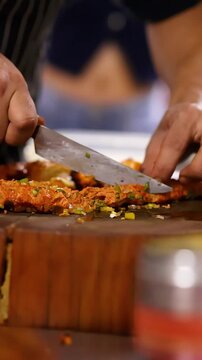 Close Up of Chef Chopping Meat Kebab on Wooden Board