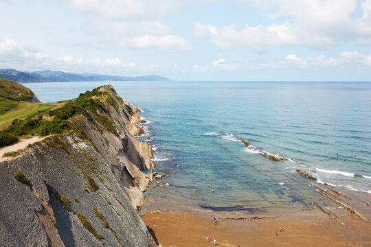 Wide angle view of dramatic flysch cliffs along Itzurun beach and Cantabrian sea in Zumaia Basque Country Spain