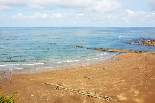 High angle panoramic view of sandy Itzurun beach with flysch rock outcrops and sea horizon in Zumaia Basque Country Spain
