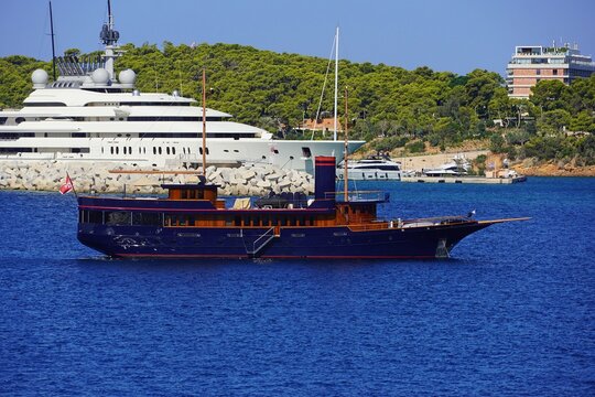 A blue luxury yacht designed to look old, near the coast of Vouliagmeni, in Athens, Greece