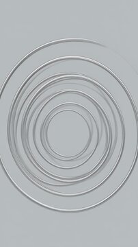 Abstract background with concentric circles forming a spiral pattern in shades of grey.