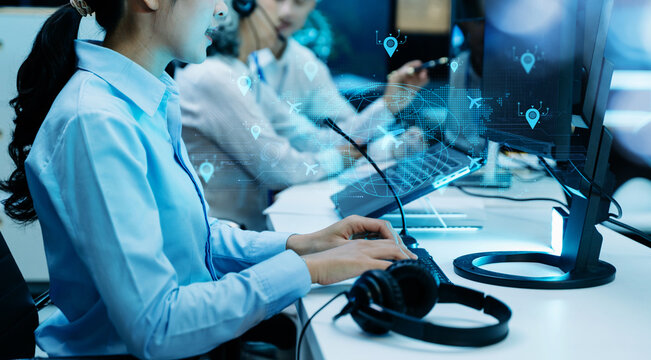 Female air traffic controller operates keyboard and monitors radar screen in navigation control center room.