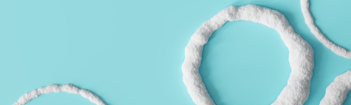 Snowy round frames are placed on a light blue background. The scene has ample space for text or design elements. This setting is suitable for winter themes