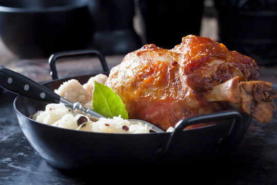 Knuckle of pork with bread dumplings and Sauerkraut in roasting tray