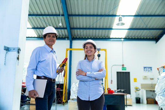 Male technician and female coworker inspect a warehouse