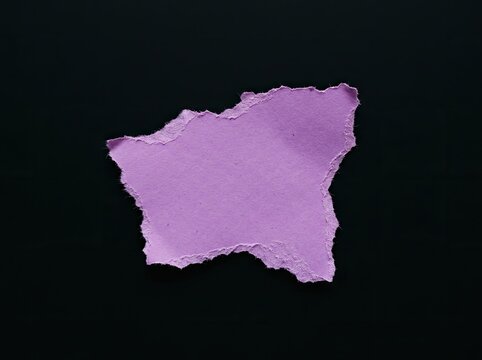 Torn purple paper piece on black background suitable for creative design copy space representing mystery individuality and hidden messages