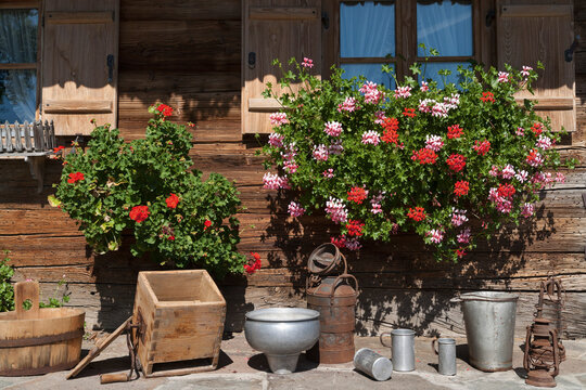 Germany, Bavaria, Geranium and househols articles on terrace of farmhouse