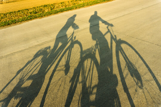 Shadows of couple on bicycles