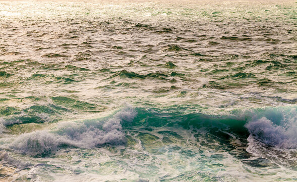 The Atlantic Ocean displays a rough breaking wave in Sagres