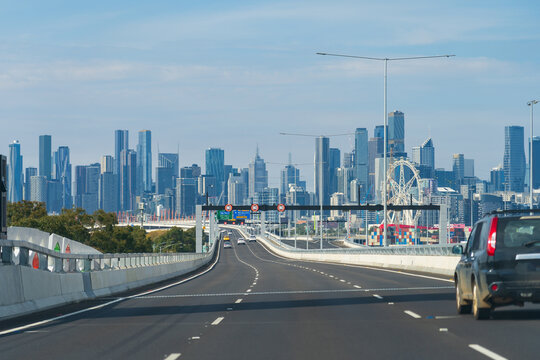 View along a multi-laned freeway toward a city skyline