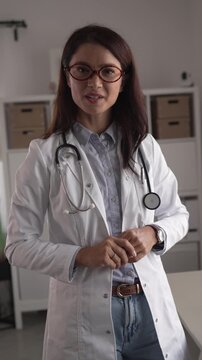 Professional female doctor speaking to camera