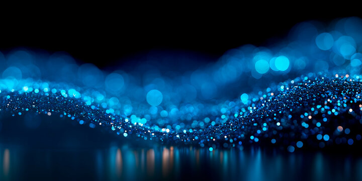 Blue bokeh lights and glowing glitter trail on dark background. Horizontal particle wave banner overlay effect for wide banner designs, sci-fi energy flows, festive lighting overlays