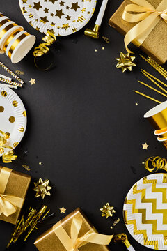 Luxury golden party supplies frame with copy space vertical black background